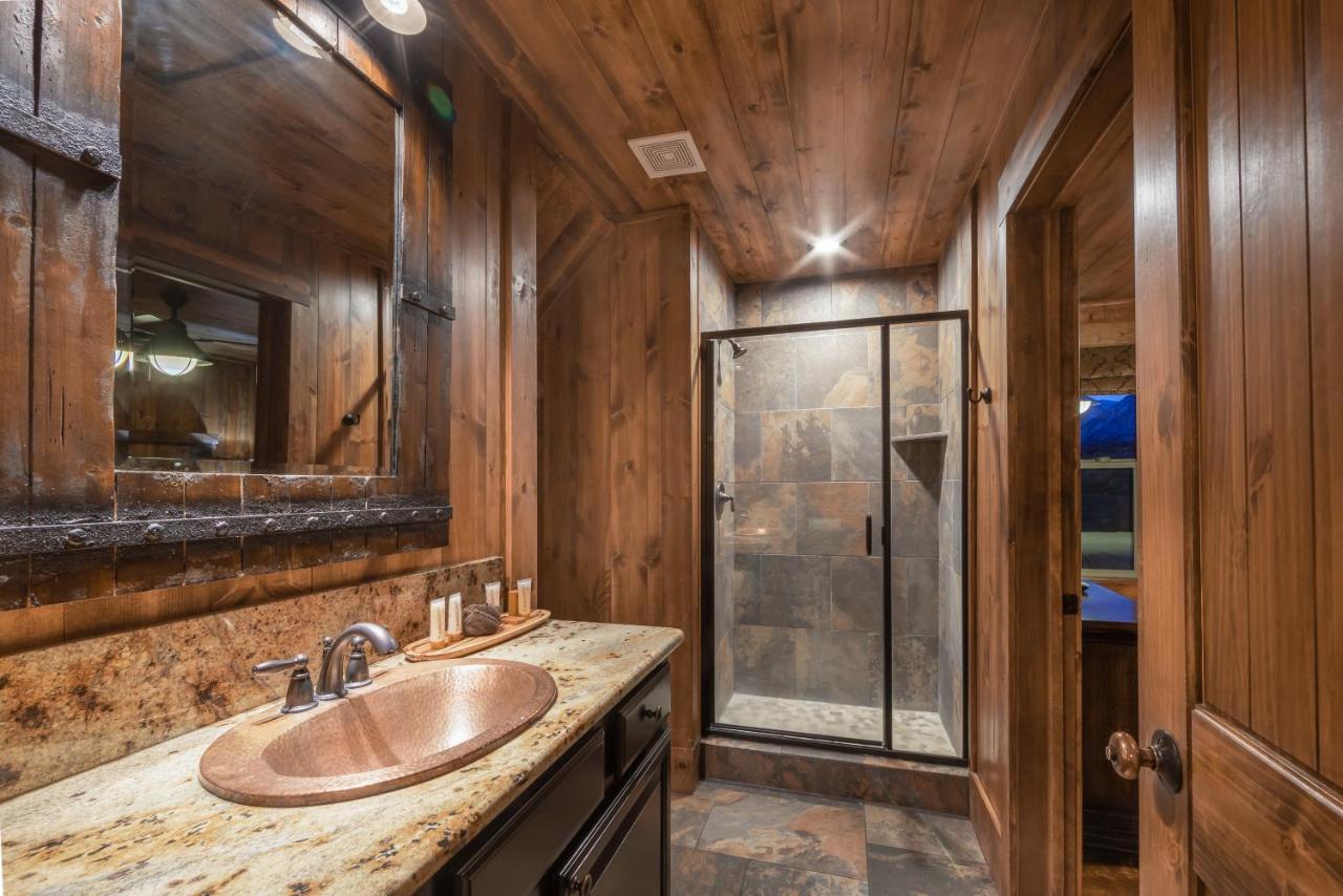 Bathroom with wood accents and glass shower.