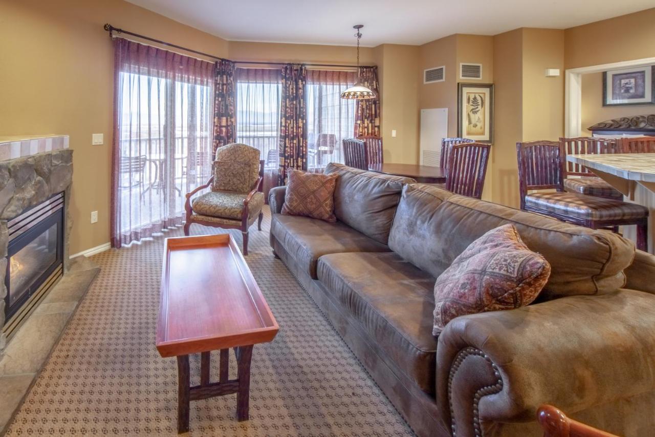 Spacious living room with patterned furniture and carpet.